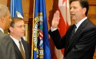 James B. Comey is sworn in as FBI Director by Attorney General Eric Holder on September 4, 2013; Chuck Rosenberg, senior counselor to Director Comey, holds the Bible.